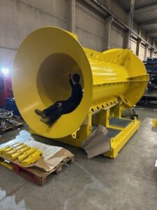 Checking the inside of The Pile Catcher hopper for precision and alignment.